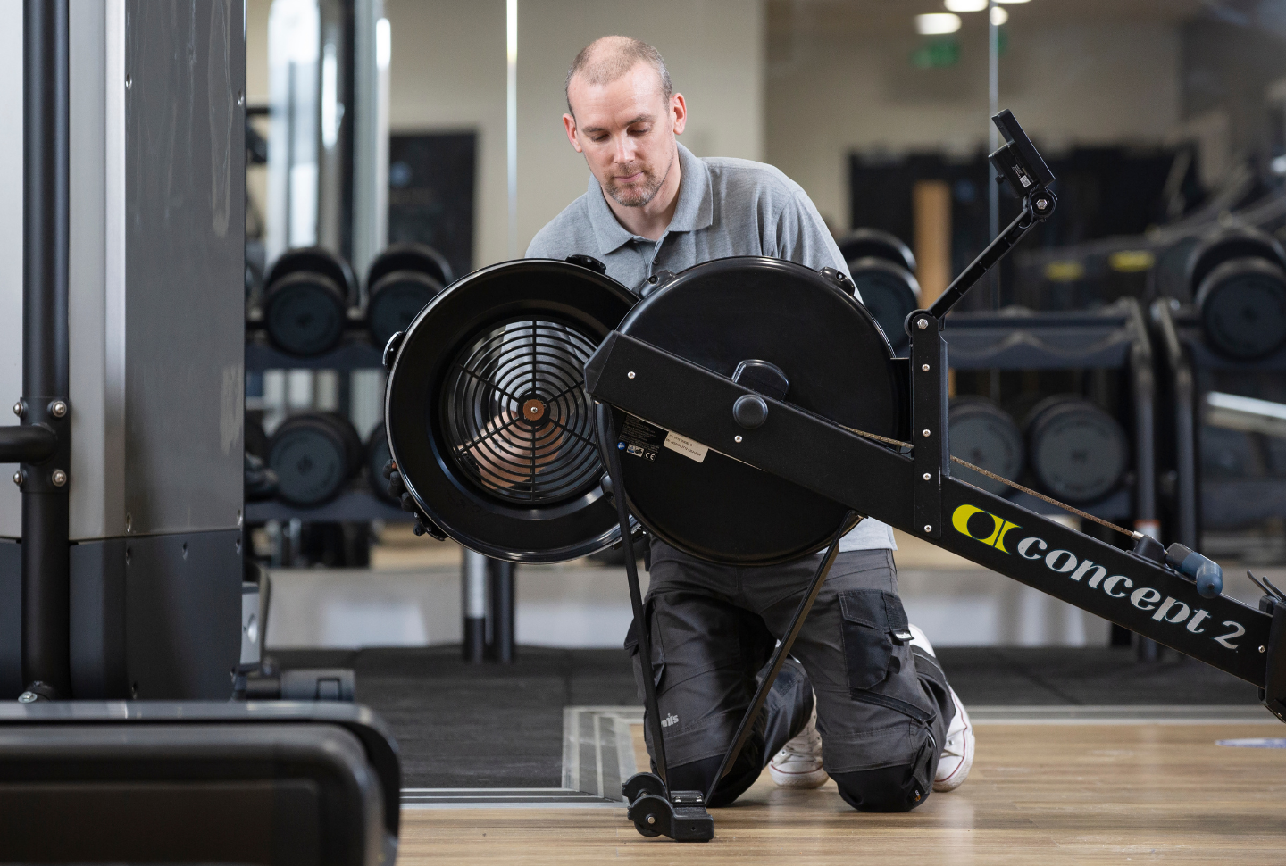 Man carrying out gym risk assessment